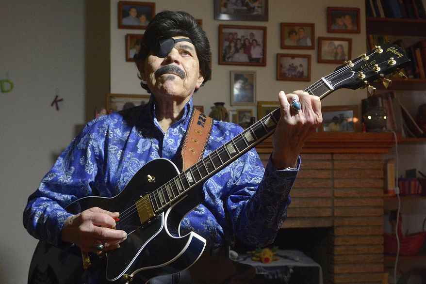 In this Jan. 14, 2016, photo, Al Hurricane picks some tunes on his guitar in Albuquerque, N.M. Al Hurricane, known as the "Godfather of New Mexico music" for developing a distinct sound bridging the state's unique Hispanic traditions with country and rock, died Sunday, Oct. 22. (Greg Sorber/The Albuquerque Journal via AP)