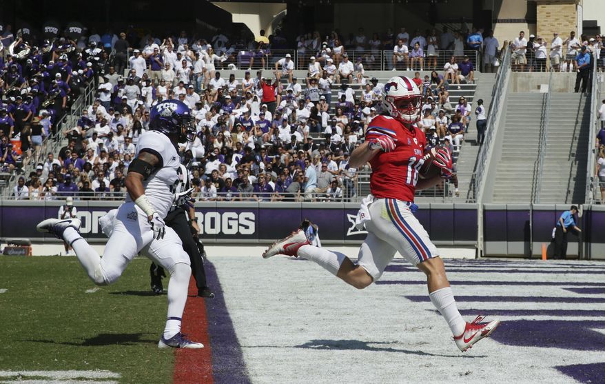 FILE - This Sept. 16, 2017 file photo shows SMU wide receiver Trey Quinn (18) beating TCU safety Niko Small (2) to the end zone for a touchdown reception during the first half an NCAA college football game in Fort Worth, Texas. SMU has completed 94 passes over the last three games. Trey Quinn has been on the receiving end of 49. (AP Photo/LM Otero)