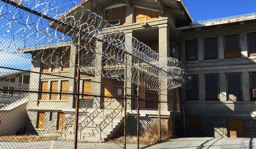 FILE- In this March 3, 2017 file photo, razor wire is coiled along a fence at the closed Mount McGregor Correctional Facility in Wilton, N.Y. Empire State Development said said Tuesday, Oct. 24, 2017 it has halted efforts to sell the former prison site for redevelopment after the three proposals that were received since the state put the site out for bid in January 2017 were rejected as unfeasible. (AP Photo/Chris Carola)