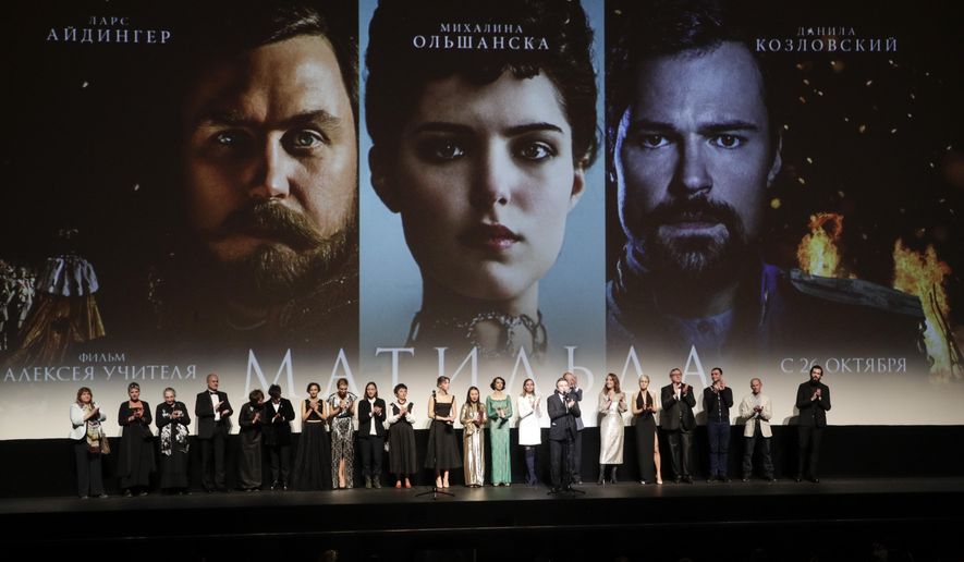 Alexei Uchitel, Russian film director of "Matilda," a movie about the last Russian czar's affair with a ballerina and his movie crew applaud at the stage at the Mariinsky Theatre in Moscow, Russia, Monday, Oct. 23, 2017. "Matilda" loosely tells the story of Nicholas II's infatuation with prima ballerina Matilda Kshesinskaya angered hard-line nationalists and some Orthodox believers in Russia, who see it as blasphemy against the emperor, glorified as a saint by the Russian Orthodox Church. (AP Photo/Dmitri Lovetsky)