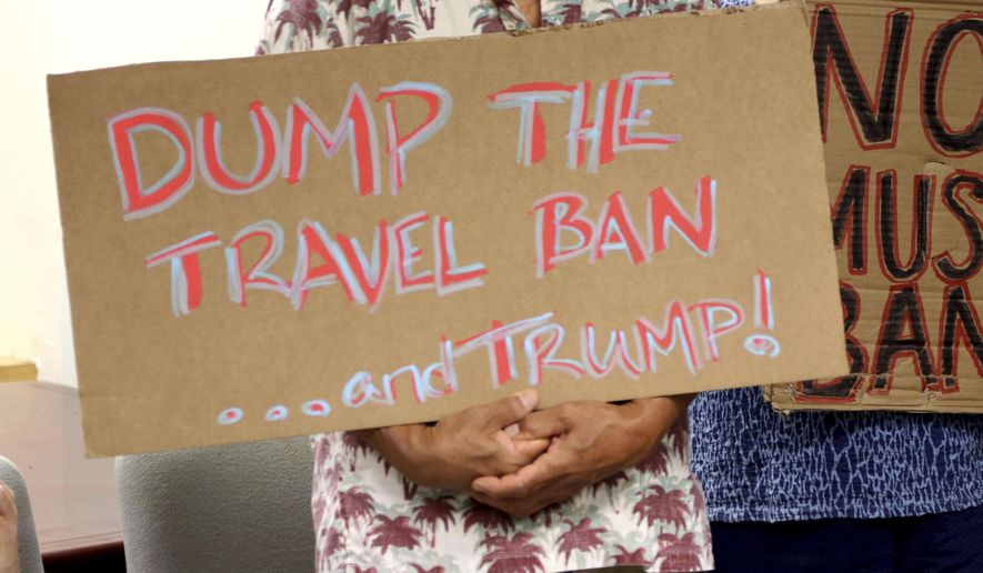 FILE- In this June 30, 2017, file photo, critics of President Donald Trump's travel ban hold signs during a news conference in Honolulu. The Trump administration is appealing a Hawaii judge's order that blocks the newest version of the travel ban. Attorneys for the U.S. government filed court papers Tuesday, Oct. 24, 2017, saying they are taking the case to the 9th U.S. Circuit Court of Appeals. The appeals court has blocked both of Trump's previous bans. (AP Photo/Caleb Jones, File)
