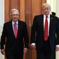 President Donald Trump, escorted by Senate Majority Leader Mitch McConnell, R-Ky., arrives on Capitol Hill to have lunch with Senate Republicans and push for his tax reform agenda, in Washington, Tuesday, Oct. 24, 2017.  (AP Photo/Manuel Balce Ceneta)