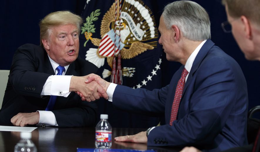 President Donald Trump shakes hands with Texas Gov. Greg Abbott during a briefing on hurricane recovery efforts, Wednesday, Oct. 25, 2017, in Dallas. (AP Photo/Evan Vucci)