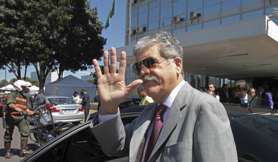 FILE- In this April 20, 2012 file photo, Argentina's then Planning Minister Julio de Vido waves to media as he leaves the Ministry of Mines and Energy in Brasilia, Brazil. Argentina's Congress is considering stripping De Vido of his immunity as current legislator, since he is being accused of corruption. (AP Photo/Eraldo Peres)
