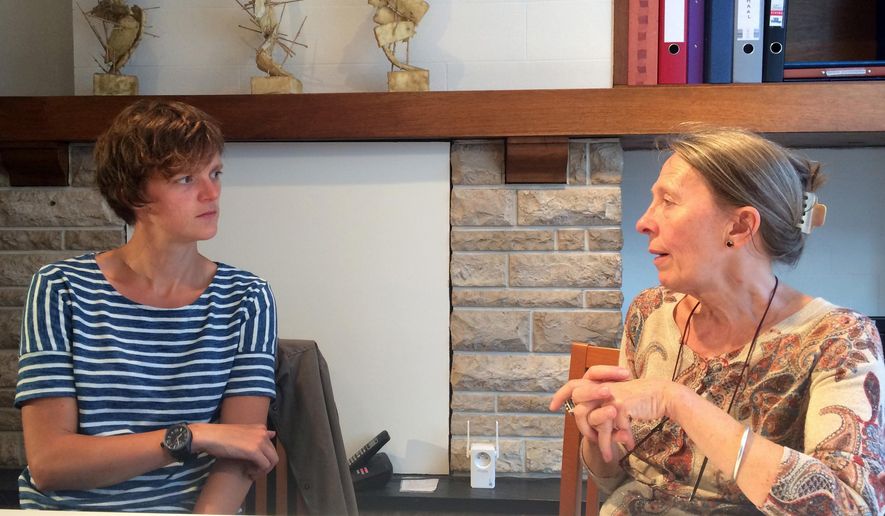 ADVANCE FOR USE THURSDAY OCT. 26, 2017 AND THEREAFTER - In this Thursday, June 29, 2017 photo, psychiatrist Dr. Lieve Thienpont, right, speaks with Amy De Schutter, who received approval for euthanasia about a year ago, in Ghent, Belgium, one of the few countries that allow for euthanasia. Thienpont, a doctor, respected psychiatrist and prominent euthanasia advocate, believes that when modern medicine can’t relieve suffering, euthanasia, when doctors actively kill patients, should be an option. (AP Photo/Maria Cheng)