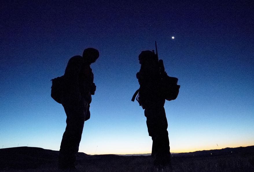 In a Oct. 15, 2017 photo, Frank Fagan, of Powell, Wyo., talks over the hunt plan before sunrise with his 12 year-old daughter, Shelby, before she pulled the trigger on her first deer during the opening day of deer season in Park County, Wyoming, on public access land near Heart Mountain Female hunters have increased in Wyoming by more than 30 percent since 2008. (Mark Davis/The Powell Tribune via AP)