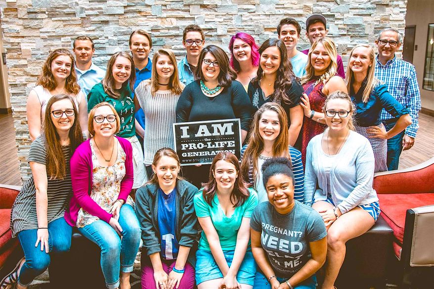 Pro-life advocate Kristan Hawkins - shown with the sign in the center of the group- is president of Students for Life, and will tour college campuses to speak out against views of "aging feminists." (Students for Life)