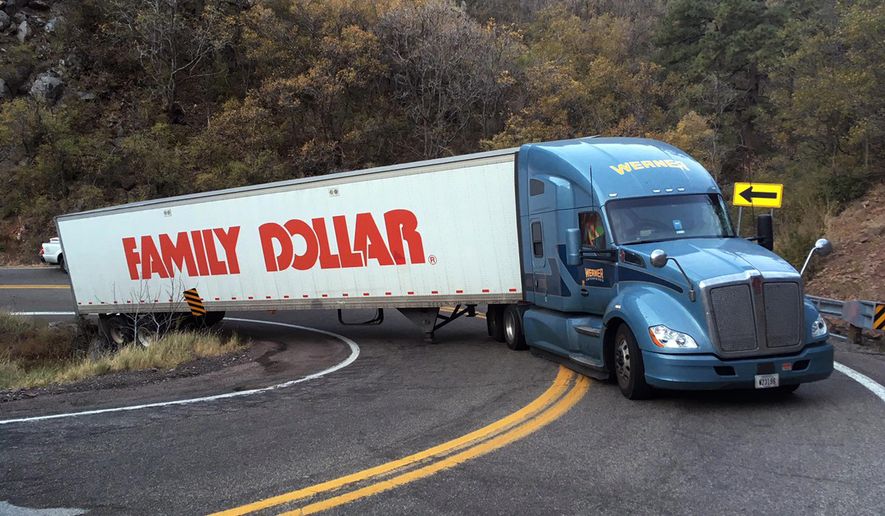 In this photo provided by the Arizona Department of Transportation, a tractor-trailer rig disabled after partially going off a sharp curve blocks a 13-mile stretch on State Route 89A near Jerome, Ariz., early Wednesday, Oct. 25, 2017. (Jesse Johnson/Arizona Department of Transportation via AP)