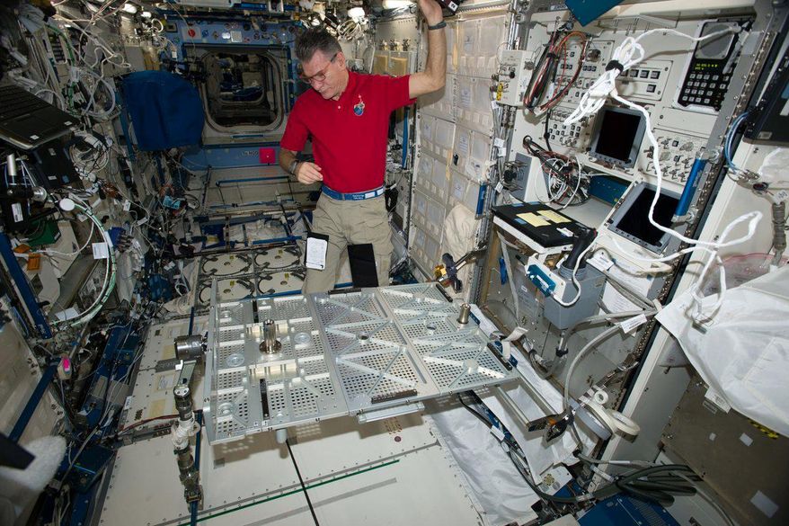 In this photo provided the European Space Agency on Wednesday, Oct. 25, 2017, Italian astronaut Paolo Nespoli looks at the Multipurpose Transporting Plate aboard the International Space Station. Pope Francis is making his first phone call off the planet - and into space. On Thursday, Oct. 26 the pope will reach out to the six astronauts on the International Space Station. It will be only the second time a pope phones the heavens like this. Pope Benedict XVI called the space station in 2011. Nespoli was aboard the orbiting lab for the first papal call, and he’s back up there again, along with three Americans and two Russians. (European Space Agency via AP)