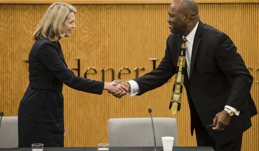 Pennsylvania Supreme Court candidates Republican Sallie Mundy, a justice on the state Supreme Court, left, and Democratic candidate Dwayne Woodruff, a common pleas court judge in Allegheny County shake hands at the end of a debate at the Widener University Commonwealth Law School in Harrisburg, Pa., Wednesday, Oct. 25, 2017. (AP Photo/Matt Rourke)