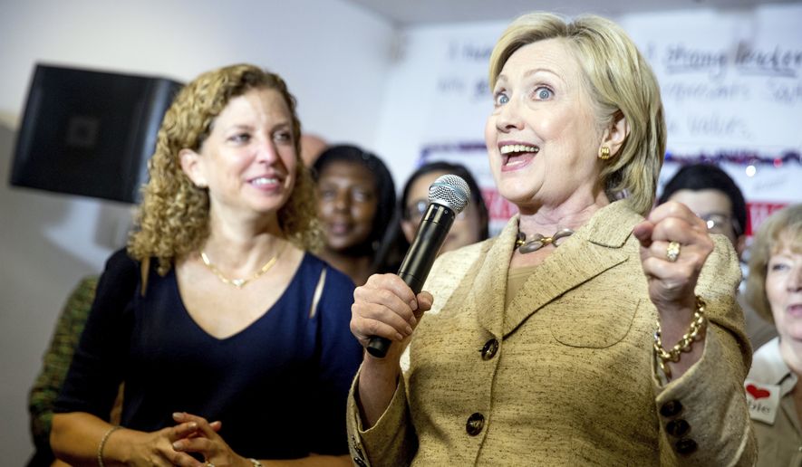 Democratic presidential candidate Hillary Clinton, right, stops in to speak to workers at a campaign office for Rep. Debbie Wasserman Schultz, D-Fla., left, in Davie, Fla., Tuesday, Aug. 9, 2016. (AP Photo/Andrew Harnik) ** FILE **