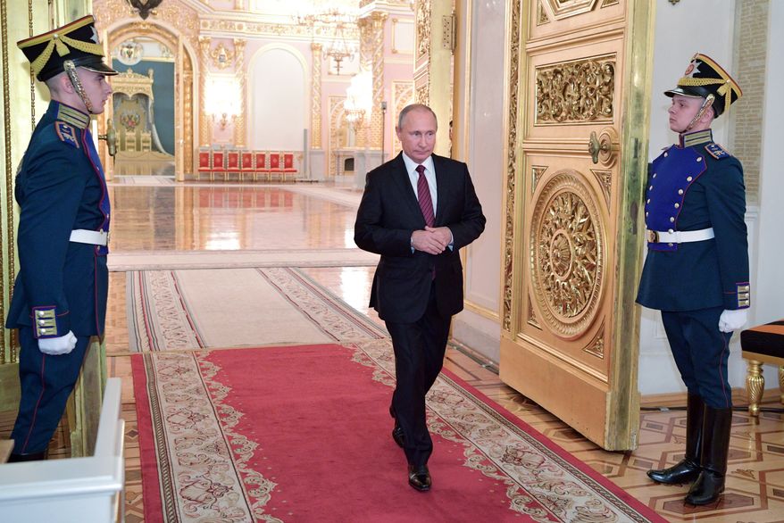 Russian President Vladimir Putin, center, enters a hall during a meeting with senior military officers in the Kremlin in Moscow, Russia, Thursday, Oct. 26, 2017. (Alexei Druzhinin, Kremlin Pool Photo via AP)