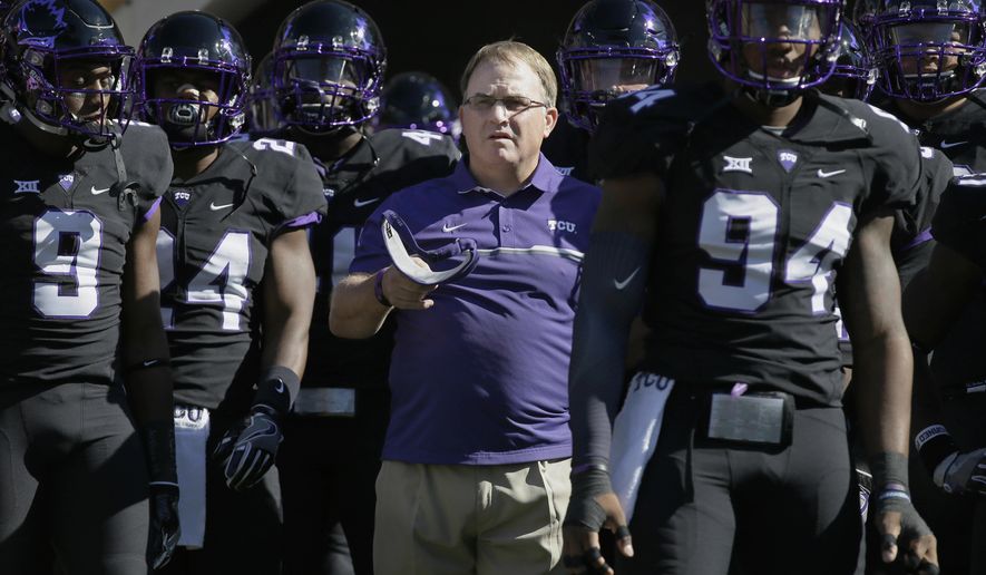 FILE - In this Oct. 1, 2016, file photo, TCU head coach Gary Patterson, center, stands with his players before an NCAA college football game against Oklahoma in Fort Worth, Texas. The Big 12 Conference has reached the midpoint of conference play with a tight race behind fourth-ranked TCU. While the Horned Frogs are the league’s only undefeated team, there is a four-way tie for second place among Top 25 teams. (AP Photo/LM Otero, File)