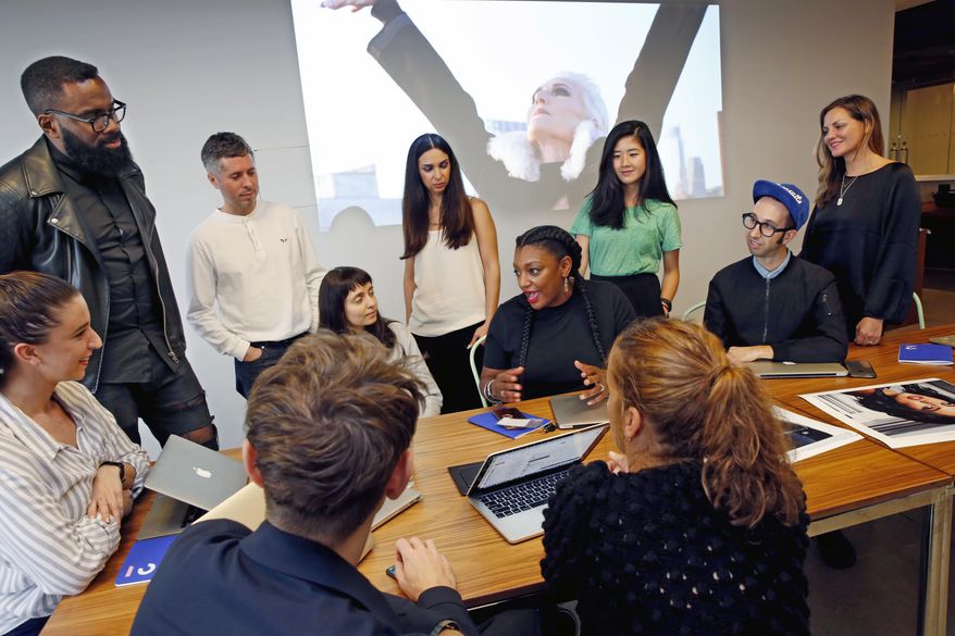 In this Tuesday, Oct. 24, 2017, photo, members of the Droga5 team behind the recent CoverGirl campaign talk about that campaign during a meeting at the advertising agency's headquarters, in New York. Creative director Ray Smiling, upper left, listens along with other team members as Shannon Washington, also a creative director, seated at center, makes her point. Diversity in the advertising industry is becoming a higher priority for consumer product companies as they try to reach a new generation of customers with evolving sensibilities on ethnicity, age, gender and sexuality. (AP Photo/Kathy Willens)