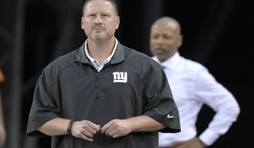 FILE - In this Sept. 18, 2017, file photo, New York Giants coach Ben McAdoo and general manager Jerry Reese, right, look on from the tunnel before an NFL football game against the Detroit Lions in East Rutherford, N.J. With a 1-6 record, the Giants probably are going to miss the playoffs for the fifth time in six seasons, and co-owners John Mara and Steve Tisch have to consider some house cleaning. (AP Photo/Bill Kostroun, File)
