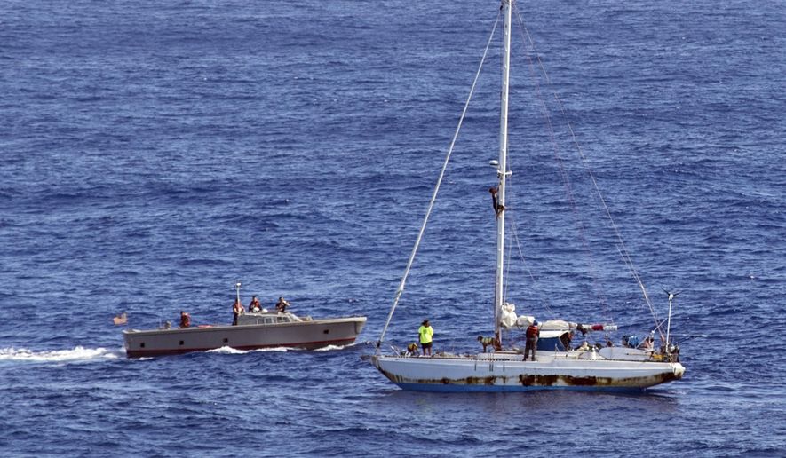 In this Wednesday, Oct. 25, 2017 photo, sailors from the USS Ashland approach a sailboat with two Honolulu women and their dogs aboard as they are rescued after being lost at sea for several months while trying to sail from Hawaii to Tahiti. The U.S. Navy rescued the women on Wednesday after a Taiwanese fishing vessel spotted them about 900 miles southeast of Japan on Tuesday and alerted the U.S. Coast Guard. The women, identified by the Navy as Jennifer Appel and Tasha Fuiaba, lost their engine in bad weather in late May, but believed they could still reach Tahiti. (Mass Communication Specialist 3rd Class Jonathan Clay/U.S. Navy via AP)
