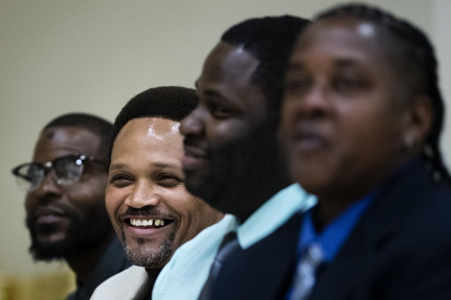 ADVANCE FOR USE MONDAY, OCT. 30, 2017 AND THEREAFTER-Paulette Carrington, foreground, and fellow juvenile lifer Courtney Boyd, second left, both participants in Uplift Solutions' job training program for former inmates, listen to remarks during a graduation ceremony from the program in Philadelphia, Monday, Oct. 16, 2017. The release of dozens of former juvenile lifers, set in motion by a U.S. Supreme Court ruling early in 2016, raises a host of questions about how those freed will navigate life on the outside. (AP Photo/Matt Rourke)