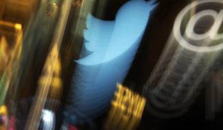 In this Wednesday, Nov. 6, 2013, file photo, the Twitter logo appears on an updated phone post on the floor of the New York Stock Exchange. (AP Photo/Richard Drew, File)