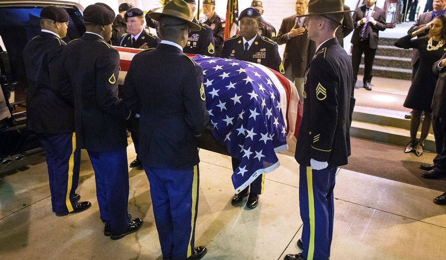 In this Oct. 25, 2017 photo, a Fort Leonard Wood Honors Team escorts the flag-draped casket with the remains of Army Staff Sgt. Michael Aiello into Staab Funeral Home in Springfield, Ill. Aiello went missing Sept. 30 1944, during intense fighting near the bridge at Nijmegen in the Netherlands. About eight years ago, the military disinterred a set of remains that were later identified as Aiello. Family members in the Springfield area provided DNA samples to confirm the identity and arrangements were made to transport the remains back to Springfield this week. (Ted Schurter /The State Journal-Register via AP)