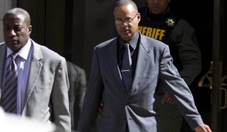 FILE - In this June 10, 2016, file photo, Officer Caesar Goodson, center, leaves the courthouse after his trial in the death of Freddie Gray in Baltimore. Goodson was acquitted but faces a disciplinary hearing beginning Monday, Oct. 30, 2017, to determine whether he will be fired from the police department. (AP Photo/Jose Luis Magana, File)