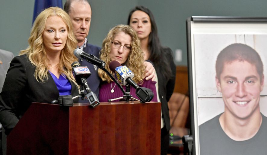 FILE – In this May 5, 2017, file photo, Centre County, Pa., District Attorney Stacy Parks Miller, left, announces findings an investigation into the death of Penn State University fraternity pledge Tim Piazza, seen in photo at right, as his parents, Jim and Evelyn Piazza, second and third from left, stand nearby during a news conference in Bellefonte, Pa. Parks Miller reinstated certain charges against members of Penn State's former Beta Theta Pi fraternity Friday, Oct. 27, 2017, nearly two months after a district judge dismissed the most serious charges of involuntary manslaughter and aggravated assault originally filed by prosecutors in response to the Feb. 4, 2017, death of 19-year-old Tim Piazza, of Lebanon, N.J., after a night of heavy drinking. (Abby Drey/Centre Daily Times via AP, File)