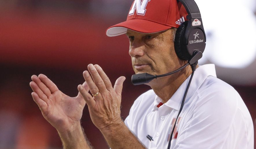 FILE - In this Sept. 2, 2017, file photo, Nebraska head coach Mike Riley applauds after a play review confirmed a touchdown by wide receiver Stanley Morgan Jr. during the first half of an NCAA college football game against Arkansas State in Lincoln, Neb. Jeff Brohm came to Purdue to win. The first-year coach still believes he can even with some midseason missteps. Nebraska coach Mike Riley understands. The Boilermakers and Cornhuskers have both lost back-to-back games. They both need three wins to become bowl eligible. And both know that the turnaround must begin Saturday night, Oct. 28, 2017 in West Lafayette, Indiana. (AP Photo/Nati Harnik, file)