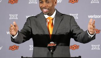 FILE - In this Monday, March 27, 2017 file photo, Oklahoma State&#39;s new head basketball coach Mike Boynton talks to members of the media during a news conference at Oklahoma State University in Stillwater, Okla. Oklahoma State coach Mike Boynton can’t wait for the season opener, for more than the typical reasons.(Steve Gooch/The Oklahoman via AP, File)