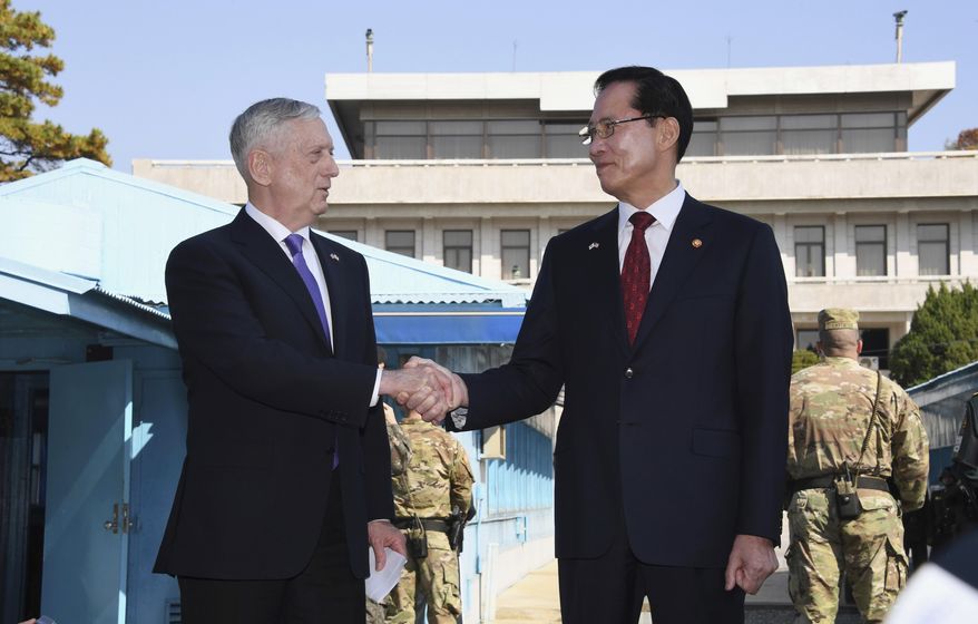 U.S. Defense Secretary Jim Mattis, left, shakes hands with South Korean Defense Minister Song Young-moo as they visit the truce village of Panmunjom in the Demilitarized Zone (DMZ) on the border between North and South Korea Friday, Oct. 27, 2017. (Jung Yeon-je/Pool Photo via AP)