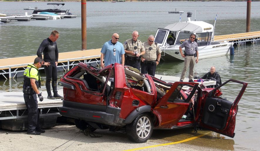 FILE - This June 2, 2016 file photo photo provided by the Ada County Sheriff's Office, deputies and the Boise Fire Department dive team stand by the wreckage of an SUV driven by a 40-year-old Boise woman that plunged off a cliff into the Lucky Peak Reservoir in Boise, Idaho. Authorities said Friday, Oct. 27, 2017 that Noel Bankhead deliberately drove her sport-utility vehicle off a cliff and into a reservoir in a crash that killed her and her three young children. The Ada County Coroner's Office ruled the deaths that occurred a triple homicide-suicide. (Patrick Orr/Ada County Sheriff's Office via AP, File)