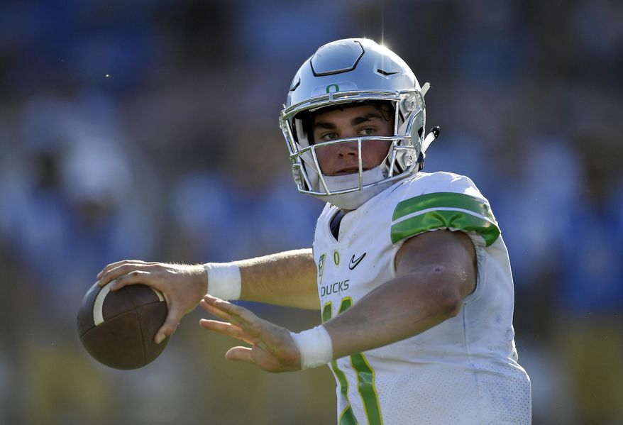 FILE - In this Oct. 21, 2017, file photo, Oregon quarterback Braxton Burmeister gets set to pass during the second half of an NCAA college football game against UCLA in Pasadena, Calif. With starting quarterback Justin Herbert out with a fractured collarbone, the Ducks have turned to true freshman Burmeister, who has had to learn on the job. (AP Photo/Mark J. Terrill, File)