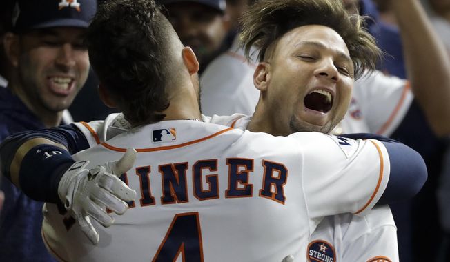 Houston Astros&#x27; Yuli Gurriel is congratulated by George Springer after hitting a home run during the second inning of Game 3 of baseball&#x27;s World Series against the Los Angeles Dodgers Friday, Oct. 27, 2017, in Houston. (AP Photo/David J. Phillip)