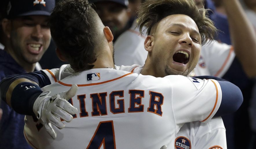 Houston Astros&#39; Yuli Gurriel is congratulated by George Springer after hitting a home run during the second inning of Game 3 of baseball&#39;s World Series against the Los Angeles Dodgers Friday, Oct. 27, 2017, in Houston. (AP Photo/David J. Phillip)
