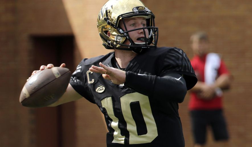 Wake Forest's John Wolford (10) looks to pass against Louisville during the first half of an NCAA college football game in Winston-Salem, N.C., Saturday, Oct. 28, 2017. (AP Photo/Chuck Burton)