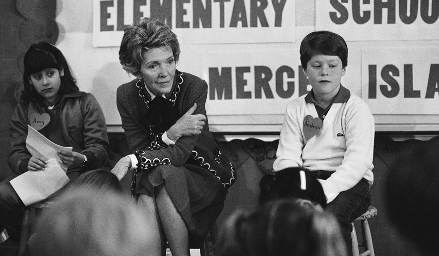 In this Feb. 14, 1984 file photo, first lady Nancy Reagan sits with a fourth and fifth grade class at Island Park Elementary School on Mercer Island, Wash., where she participated in a drug education class. At left is Amy Clarfeld, 10, and Andrew Cary, 10, is at right. During a visit with schoolchildren in Oakland, Calif., Reagan later recalled, &amp;quot;A little girl raised her hand and said, &#x27;Mrs. Reagan, what do you do if somebody offers you drugs?&#x27; And I said, &#x27;Well, you just say no.&#x27; And there it was born.&amp;quot; (AP Photo/Barry Sweet, File)  **FILE**