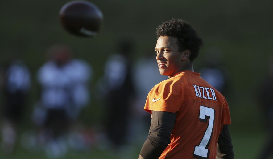 Cleveland Browns quarterback Deshone Kizer throws the ball behind his back during a training session at Pennyhill Park Hotel in Bagshot, England, Friday Oct. 27, 2017. The Cleveland Browns are preparing for an NFL regular season game against the The Minnesota Vikings in London on Sunday. (AP Photo/Tim Ireland)
