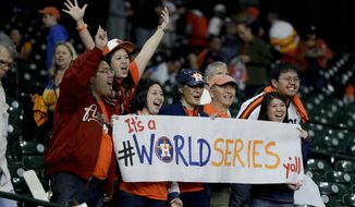 Houston Astros fans celebrate after there win against the Los Angeles Dodgers during Game 3 of baseball&#39;s World Series Friday, Oct. 27, 2017, in Houston. The Astros won 5-3 to take a 2-1 lead in the series. (AP Photo/Charlie Riedel)