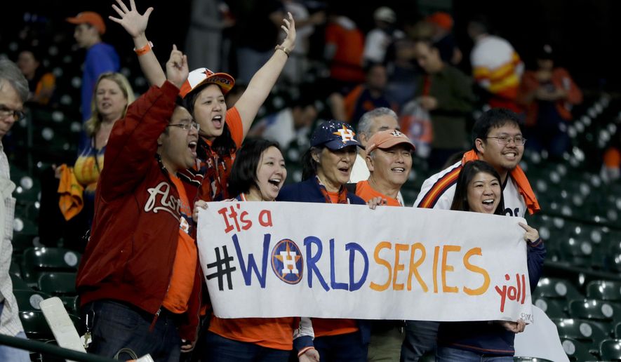 Houston Astros fans celebrate after there win against the Los Angeles Dodgers during Game 3 of baseball&#x27;s World Series Friday, Oct. 27, 2017, in Houston. The Astros won 5-3 to take a 2-1 lead in the series. (AP Photo/Charlie Riedel)