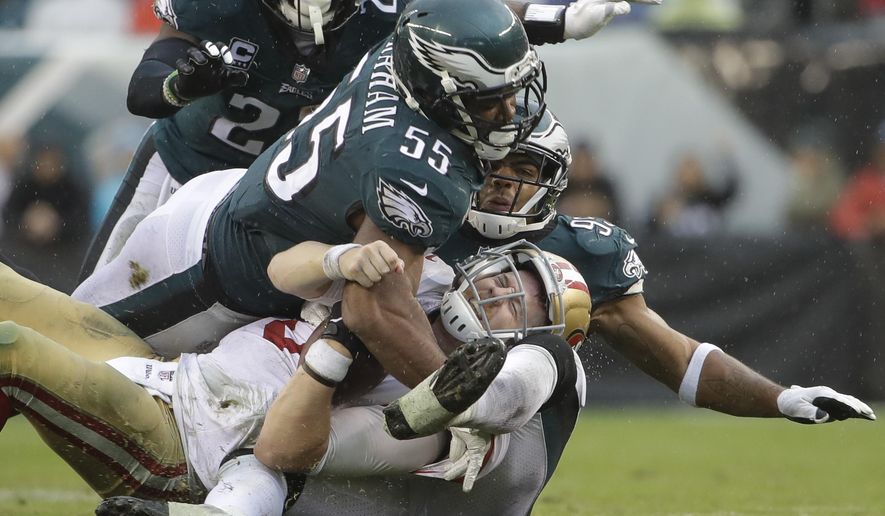 San Francisco 49ers' C.J. Beathard (3) is sacked by Philadelphia Eagles' Brandon Graham (55) and Mychal Kendricks (95) during the second half of an NFL football game, Sunday, Oct. 29, 2017, in Philadelphia,. (AP Photo/Michael Perez)