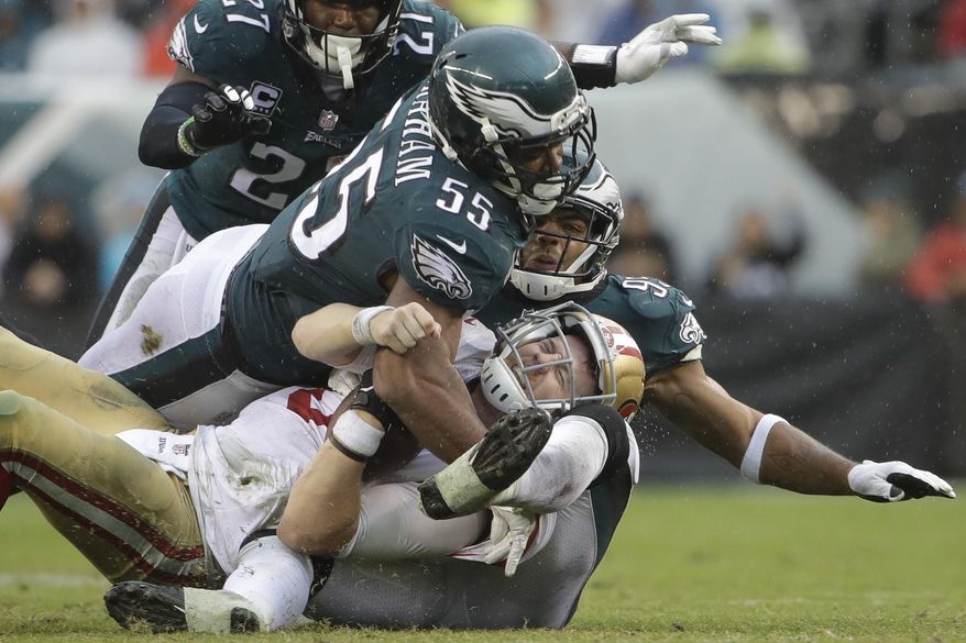 San Francisco 49ers' C.J. Beathard (3) is sacked by Philadelphia Eagles' Brandon Graham (55) and Mychal Kendricks (95) during the second half of an NFL football game, Sunday, Oct. 29, 2017, in Philadelphia,. (AP Photo/Michael Perez)