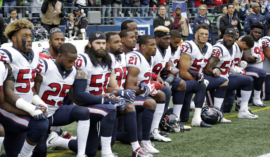 Houston Texans players kneel during the singing of the national anthem before an NFL football game against the Seattle Seahawks, Sunday, Oct. 29, 2017, in Seattle. (AP Photo/Elaine Thompson)