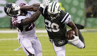 New York Jets&#39; Bilal Powell (29) stiff-arms Atlanta Falcons&#39; Keanu Neal (22) during the first half of an NFL football game, Sunday, Oct. 29, 2017, in East Rutherford, N.J. (AP Photo/Bill Kostroun)