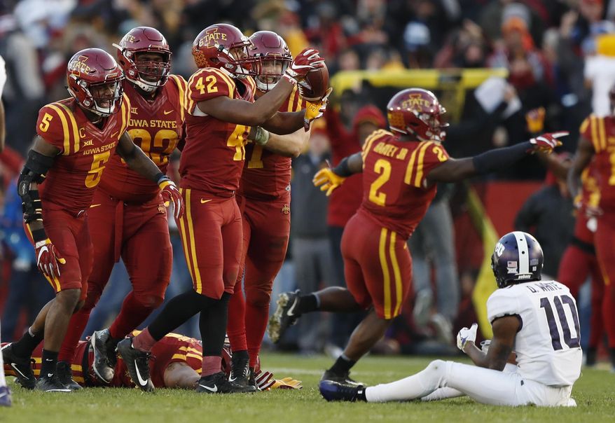 Iowa State linebacker Marcel Spears Jr. (42) celebrates with teammates after intercepting a pass in front of TCU wide receiver Desmon White (10) during the second half of an NCAA college football game, Saturday, Oct. 28, 2017, in Ames, Iowa. Iowa State won 14-7. (AP Photo/Charlie Neibergall)