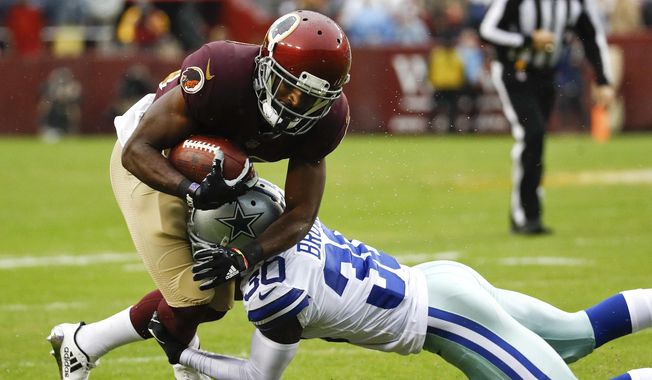 Washington Redskins wide receiver Jamison Crowder (80) is stopped by Dallas Cowboys cornerback Anthony Brown (30) during the first half of an NFL football game in Landover, Md., Sunday, Oct. 29, 2017. (AP Photo/Patrick Semansky)