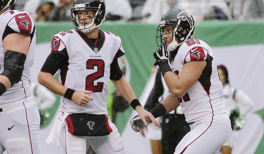 Atlanta Falcons quarterback Matt Ryan (2) celebrates with teammate Austin Hooper after they connected for a touchdown during the first half of an NFL football game against the New York Jets, Sunday, Oct. 29, 2017, in East Rutherford, N.J. (AP Photo/Seth Wenig)