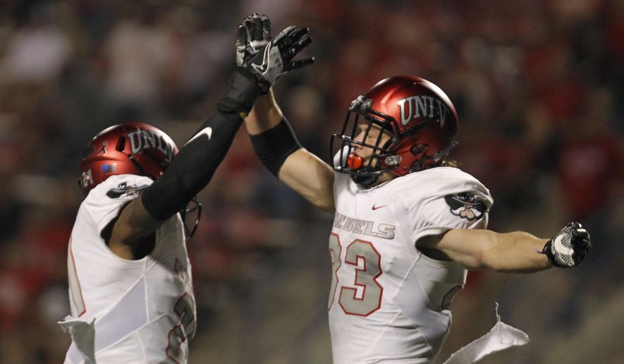 From left to right, UNLV's Chauncey Scissum and Dalton Baker celebrate a victory over Fresno State during the second half of an NCAA college football game that UNLV won 26-16 in Fresno, Calif., Saturday, Oct. 28 2017. (AP Photo/Gary Kazanjian)