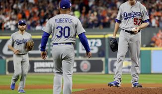 Los Angeles Dodgers starting pitcher Alex Wood, right, is taken out of the game by manager Dave Roberts during the sixth inning of Game 4 of baseball&#x27;s World Series against the Houston Astros Saturday, Oct. 28, 2017, in Houston. (AP Photo/Matt Slocum)