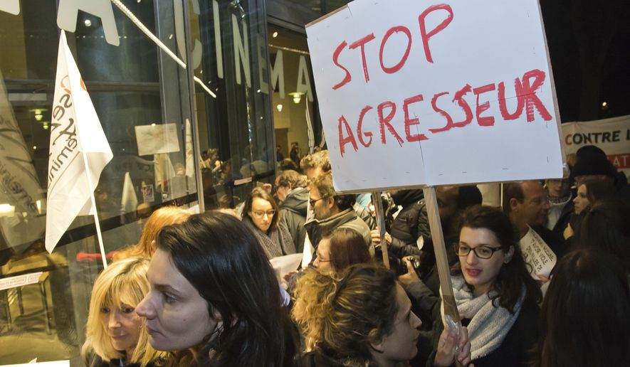 French feminist groups protest outside the film institute La Cinematheque Francaise in Paris, France, Monday, Oct. 30, 2017. French feminist groups have staged a protest against a retrospective honoring director Roman Polanski at France&#x27;s famed film institute La Cinematheque Francaise. Placard reads, &quot;stop the aggressor&quot;. (AP Photo/Michel Euler)