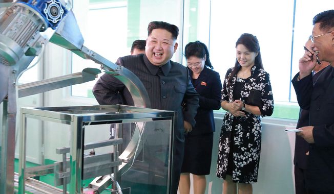In this undated photo provided Sunday, Oct. 29, 2017, by the North Korean government,  North Korean leader Kim Jong-un, center, visits a cosmetics factory in Pyongyang, North Korea. At second from right is Kim&#x27;s wife Ri Sol-ju. Independent journalists were not given access to cover the event depicted in this image distributed by the North Korean government. The content of this image is as provided and cannot be independently verified. (Korean Central News Agency/Korea News Service via AP)