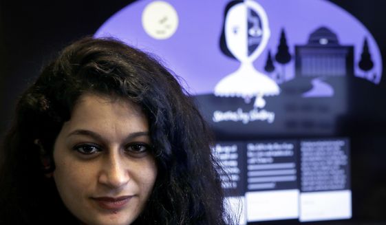 In this Tuesday, Oct. 24, 2017 photo, co-creator of a fiction-writing &#39;chatbot,&#39; Massachusetts Institute of Technology postdoctoral associate Pinar Yanardag, of Istanbul, Turkey, sits for a photograph in front of a graphic from the home page of the site called &amp;quot;Shelley.&amp;quot; Named after &amp;quot;Frankenstein&amp;quot; author Mary Shelley, the chatbot has been trained on more than 140,000 horror stories written by amateur writers on a popular online forum. Now Shelley is generating its own stories on Twitter, taking turns with humans in an experiment to find out if artificial intelligence is smart enough to make someone feel scared. (AP Photo/Steven Senne)