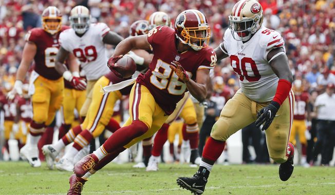 FILE - In this Sunday, Oct. 15, 2017 file photo, Washington Redskins tight end Jordan Reed (86) carries the ball during the first half of an NFL football game against the San Francisco 49ers in Landover, Md. Tight end Jordan Reed and defensive lineman Matt Ioannidis are among the injured Washington Redskins players who are expected to miss their upcoming game at the Seattle Seahawks on Sunday, Nov. 5, 2017. (AP Photo/Alex Brandon) ** FILE **